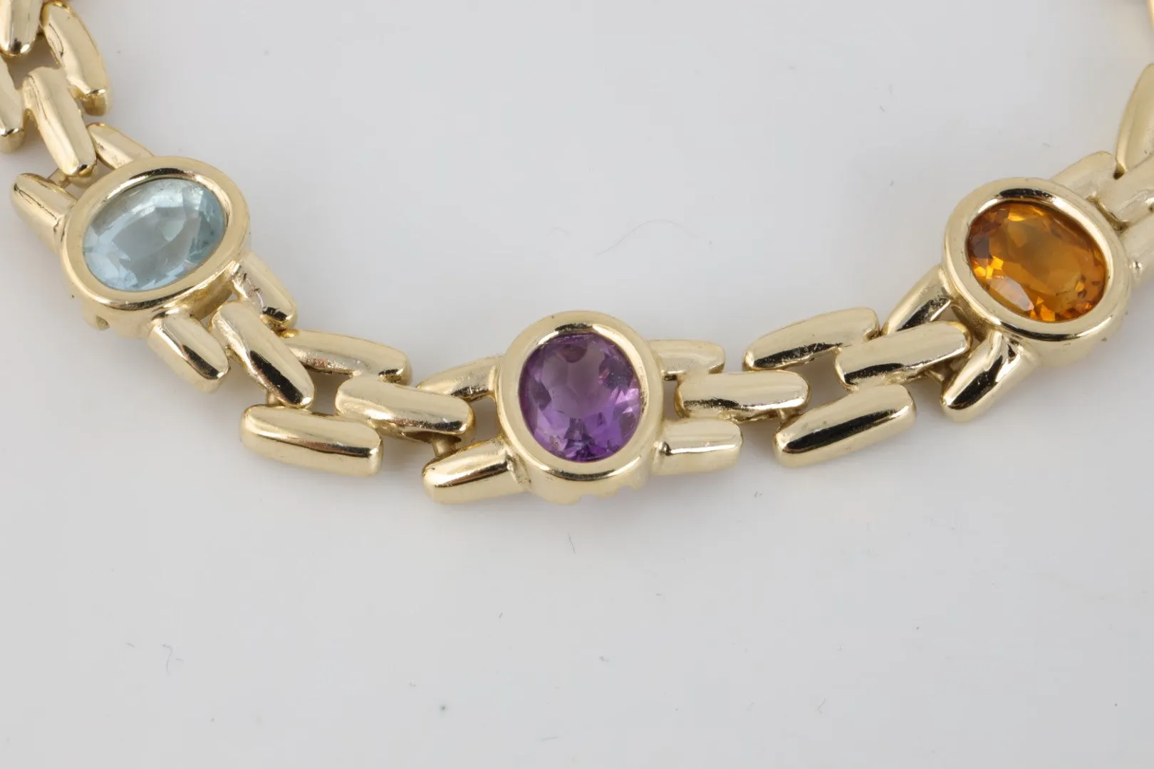 7” 14k Yellow Gold Amethyst, Blue Topaz, Citrine & Garnet Bracelet (19.10g.)